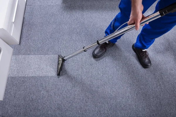 A man performing carpet cleaning